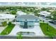 Aerial view of a two-story house with a large driveway at 83 Palm Blvd, Dunedin, FL 34698