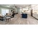 Open concept living room and kitchen with hardwood floors and stylish furniture at 83 Palm Blvd, Dunedin, FL 34698
