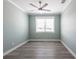 Bright bedroom featuring wood-look flooring and a ceiling fan at 83 Palm Blvd, Dunedin, FL 34698