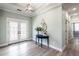 Light and airy entryway with hardwood floors and double doors at 83 Palm Blvd, Dunedin, FL 34698