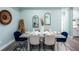 Open concept dining room with seating for six and wood table at 83 Palm Blvd, Dunedin, FL 34698