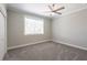 Bright bedroom with gray carpet and ceiling fan at 83 Palm Blvd, Dunedin, FL 34698