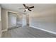 Bedroom with mirrored closet doors and wood-look floors at 6406 Butte Ave, New Port Richey, FL 34653