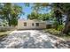 Charming bungalow-style home with a gravel driveway and fenced yard at 4000 7Th N Ave, St Petersburg, FL 33713