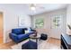 Bright living room with a blue sofa and ceiling fan at 4000 7Th N Ave, St Petersburg, FL 33713