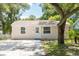 Quaint house with a gravel driveway and mature trees at 4000 7Th N Ave, St Petersburg, FL 33713