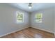 Spacious bedroom with light walls, wood flooring, and ceiling fan at 4000 7Th N Ave, St Petersburg, FL 33713