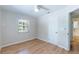 Bright bedroom with wood flooring, ceiling fan, and access to bathroom at 4000 7Th N Ave, St Petersburg, FL 33713
