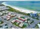 Aerial view of condo building near beach, showing pool and parking at 6800 Sunset Way # 204, St Pete Beach, FL 33706