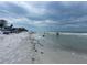 Beach view with people enjoying the sand and water at 19417 Gulf Blvd # B208, Indian Rocks Beach, FL 33785