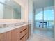 Modern bathroom with double vanity, glass shower, and water view at 5120 Marina Way # 3303, Tampa, FL 33611