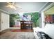 Living room features a nature wall mural and comfy seating at 1025 82Nd N Ter # 1025D, St Petersburg, FL 33702