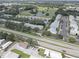An aerial view of townhomes and golf course, highlighting the community's proximity to recreational amenities and manicured landscaping at 9247 Jakes Path, Largo, FL 33771