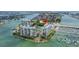 Aerial view of waterfront condos with marina and bridge in the background at 9525 Blind Pass Rd # 505, St Pete Beach, FL 33706