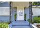 Front entrance with white door, ornate iron railings, and potted plants at 2020 58Th S St, Gulfport, FL 33707