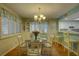 Bright dining area with a round table and four chairs, hardwood floors and a chandelier at 9247 Jakes Path, Largo, FL 33771