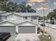 Two-car attached garage, gray doors, driveway parking at 9247 Jakes Path, Largo, FL 33771