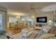 Open concept living room and dining area with hardwood floors and light blue furniture at 9247 Jakes Path, Largo, FL 33771