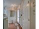 Bright entryway with hardwood floors, white doors, and a mirror at 9247 Jakes Path, Largo, FL 33771