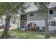 Private backyard with patio, landscaping, and AC units at 9247 Jakes Path, Largo, FL 33771