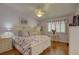 Lavender bedroom with floral bedding, hardwood floors, ceiling fan, and walk-in closet at 9247 Jakes Path, Largo, FL 33771