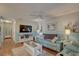 Relaxing living room with light blue couch, hardwood floors, and a large TV at 9247 Jakes Path, Largo, FL 33771