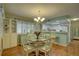 Bright dining area with a round table and four chairs, hardwood floors and a chandelier at 9247 Jakes Path, Largo, FL 33771