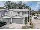 Gray two-story townhouse with attached garage and landscaped front yard at 9247 Jakes Path, Largo, FL 33771