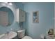 Small bathroom with white vanity, toilet and light blue walls at 9247 Jakes Path, Largo, FL 33771