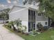 Two-story home with gray siding, screened porch, and landscaping at 9247 Jakes Path, Largo, FL 33771