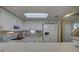 Bright kitchen with white cabinets and stainless steel appliances at 9247 Jakes Path, Largo, FL 33771