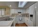 Bright kitchen with white cabinets and stainless steel appliances at 9247 Jakes Path, Largo, FL 33771