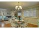 Bright dining area with a round table and four chairs, hardwood floors and a chandelier at 9247 Jakes Path, Largo, FL 33771