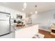 Open concept kitchen with granite island and white shaker cabinets at 2506 N Rocky Point Dr # 274, Tampa, FL 33607