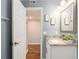 Bathroom with granite countertop, updated vanity, and a door to another room at 2506 N Rocky Point Dr # 274, Tampa, FL 33607