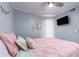 Bedroom with a pink comforter and wood floors at 2506 N Rocky Point Dr # 274, Tampa, FL 33607