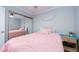 Bright bedroom with a pink comforter and mirrored closet doors at 2506 N Rocky Point Dr # 274, Tampa, FL 33607