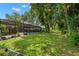 Large backyard with lush landscaping and pool at 3045 Kevlyn Ct, Safety Harbor, FL 34695