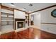 Gathering room with hardwood floors, built-in shelving, and fireplace at 3045 Kevlyn Ct, Safety Harbor, FL 34695