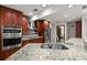 Updated kitchen features granite countertops, stainless steel appliances, and ample cabinetry at 3045 Kevlyn Ct, Safety Harbor, FL 34695