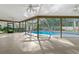 Screened pool and patio with view of trees at 3045 Kevlyn Ct, Safety Harbor, FL 34695