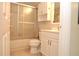 A neutral toned bathroom featuring a shower and a vanity at 3455 Countryside Blvd # 15, Clearwater, FL 33761