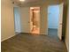 Comfortable main bedroom with three doors leading to closet and bathroom at 3455 Countryside Blvd # 15, Clearwater, FL 33761