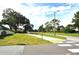 View of the St. Tropez community entrance with manicured lawns and lush landscaping at 3455 Countryside Blvd # 15, Clearwater, FL 33761