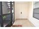 A screened entryway with tile flooring and a rug at 3455 Countryside Blvd # 15, Clearwater, FL 33761