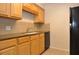 Well-equipped kitchen featuring wood cabinetry, granite countertops, and a stainless steel sink at 3455 Countryside Blvd # 15, Clearwater, FL 33761