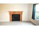 Inviting living room with a decorative fireplace, tile flooring, and a large window at 3455 Countryside Blvd # 15, Clearwater, FL 33761
