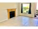 Bright living room featuring a cozy fireplace, neutral tile flooring, and natural light at 3455 Countryside Blvd # 15, Clearwater, FL 33761