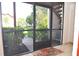 Inviting screened in patio surrounded by lush landscape and view to parking area at 3455 Countryside Blvd # 15, Clearwater, FL 33761