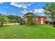 Large grassy backyard with fenced perimeter, mature trees, and a storage shed at 6195 28Th N Ave, St Petersburg, FL 33710